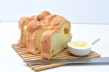 Big bread with cheese, grated parmesa cheese on white wooden background