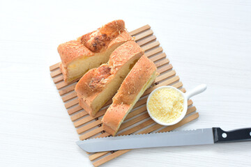 Big bread with cheese, grated parmesa cheese on white wooden background