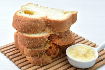 Big bread with cheese, grated parmesa cheese on white wooden background