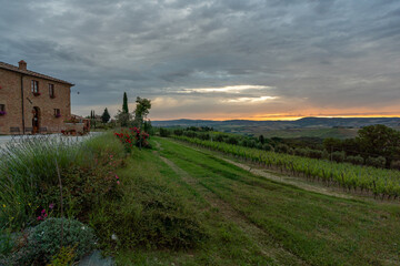 Fototapeta premium adorable sunrise in Tuscany, Italy, cloudy morning, spring time, clouds in the sky