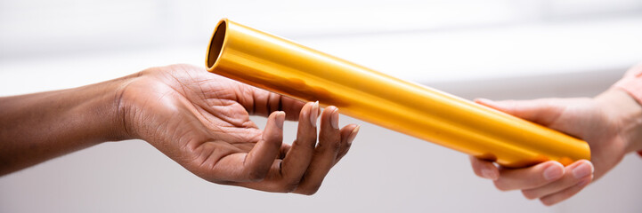 Passing Golden Relay Baton To Other Person
