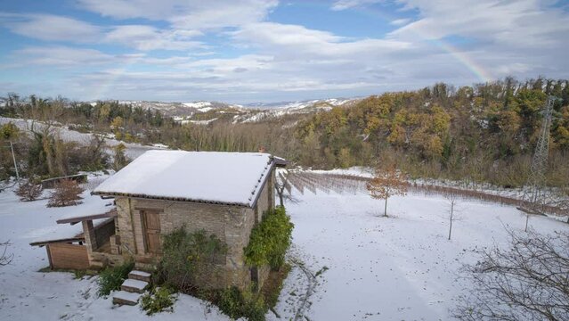 Time lapse of a rainbow and clouds on a snowy landscape, Emilia Romagna, Italy