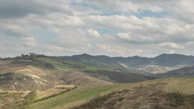 Time lapse on the gentle hills of Bologna with clouds moving and light dancing on the hills, Emilia Romagna, Italy