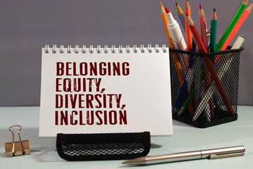 Belonging, Inclusion, Diversity, Equity, Identity write on notes isolated on Wooden Table