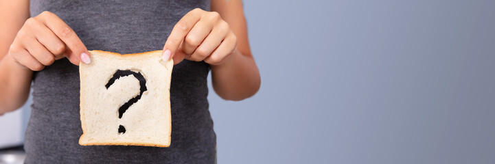 Woman Holding Slice Of Bread With Question Mark Sign