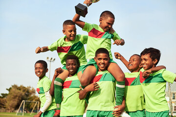 Play with passion and you will win. Shot of a boys soccer team celebrating their victory on a sports field. © T Hover/peopleimages.com