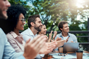 Great things will continue to emerge for them. Shot of a group of colleagues applauding during a meeting at a cafe.