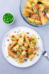Bacon and onion potato salad dressed with apple cider vinegar and mustard, on plate, vertical, top