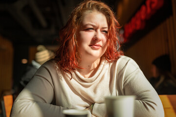 Portrait of a beautiful young red-haired plump girl close-up.