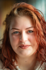 Naklejka premium Portrait of a beautiful young red-haired plump girl close-up.