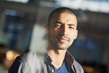 Business needs Ill take care of it. Portrait of a young businessman standing in his office.