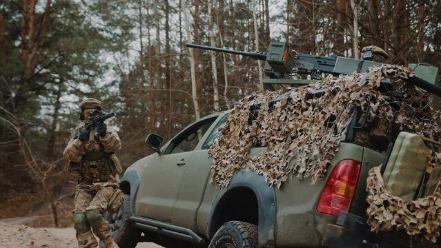 Female soldier defending backup patrol armoury army truck unit in a forest in Eastern Europe. High quality 4k footage