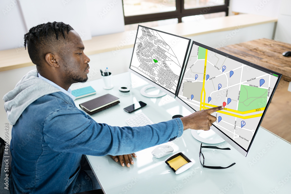 Poster businessperson analyzing cadastre map on computer