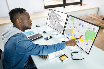 Businessperson Analyzing Cadastre Map On Computer