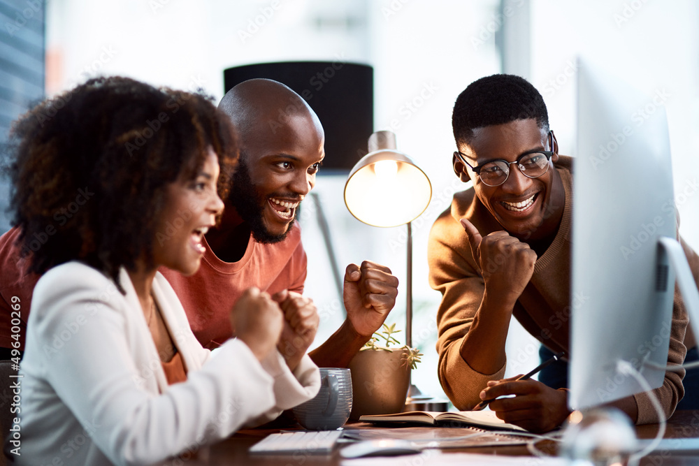Poster we do se well when we work together. shot of a group of businesspeople looking at something on a com