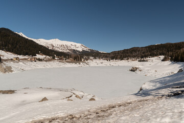 Frozen lake of Davos on a sunny winter day in Switzerland