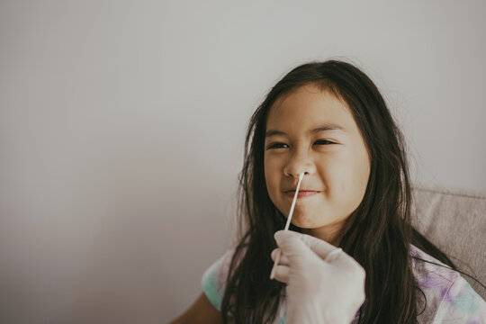 Mixed Asian Preteen Girl Getting Nasal Swab Test At Home, Covid Quick Rapid Self Test, Kid Antigen Test, New Normal Concept