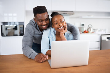 Can I join in on the fun. Shot of a young couple looking at something on a laptop.