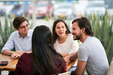 What a year its been. Shot of a group of cheerful young business colleagues enjoying a work function together at a restaurant.