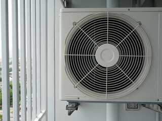closeup of air conditioner compressor outside building.	
