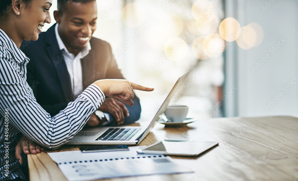 Poster getting their tasks all in order. shot of two businesspeople working together on a laptop in an offi