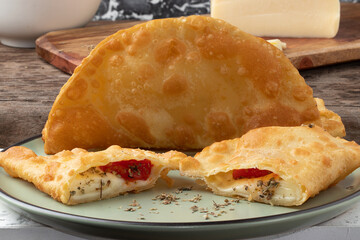 Brazilian pizza pastel stuffed with cheese, tomato and oregano. selective focus.