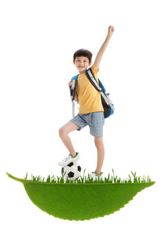 The happy little boy playing football Composite image