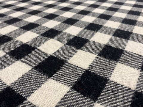 Black and white tartan square background. Black and white fabric. Close-up gingham fabric background. Plaid.
