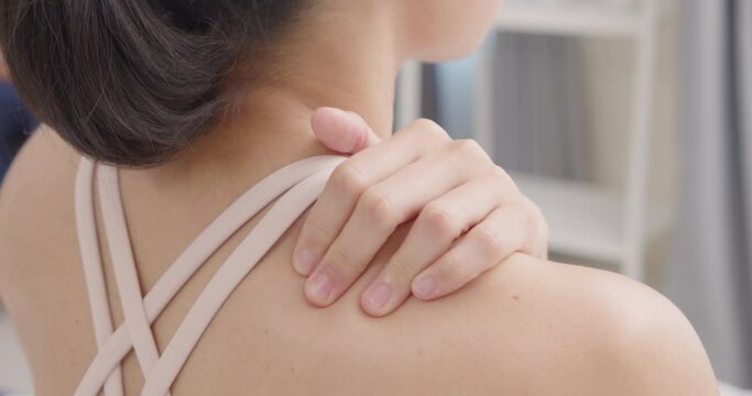 Close-up A Female hands massaging shoulders due to aches and pains.Health problems .Slow motion.