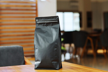 Photo of coffee packaging standing pouch size 1 Kg on the cafe table. suitable for mock up label...