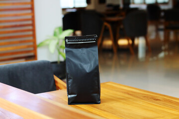 Photo of coffee packaging standing pouch size 1 Kg on the cafe table. suitable for mock up label stickers, coffee variant packaging stickers or etc. - Powered by Adobe