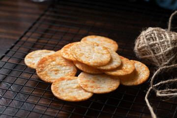 Crispy crackers on a black circle, black top view.