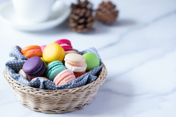Macarons in a basket and hot tea