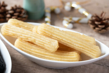 churros sticks typical of Spain with charcoal and vanilla