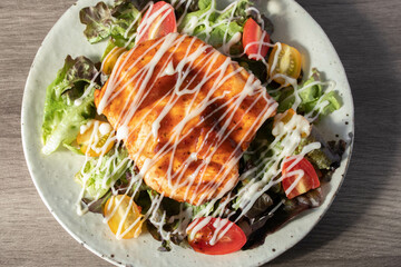 Baked chicken steak with vegetables in a plate.