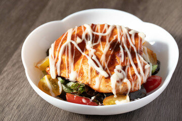 Baked chicken steak with vegetables in a plate.