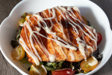 Baked chicken steak with vegetables in a plate.