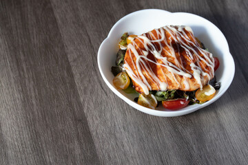 Baked chicken steak with vegetables in a plate.