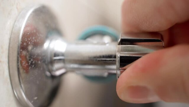 Opening a corner wall water valve close-up. Closing and opening water in household appliances