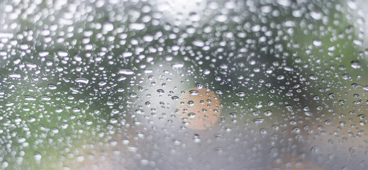 blurry raindrops at the windshield, selection focus.soft raindrops background.
