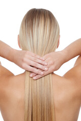 Her hair is her crowning glory. Rear view of a young blonde woman holding her hair against a white backgrouhnd.