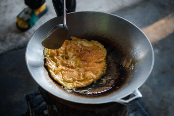 Thai style omelet in Thai street food restaurant