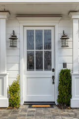 Front door that is white in color with two lamp fixtures and potted plants.