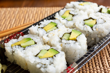 A closeup view of an avocado cut roll.