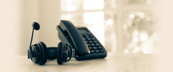 Customer service concept. Close-up headphone and telephone for communication helpdesk IT support or call center and online services.