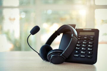 Obraz na płótnie Canvas Customer service concept. Close-up headphone and telephone for communication helpdesk IT support or call center and online services.