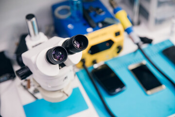 Repair of modern mobile phones and electronic devices with microscope, top view