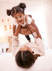So much fun with mommy. Shot of a little girl playing with her mother at home.