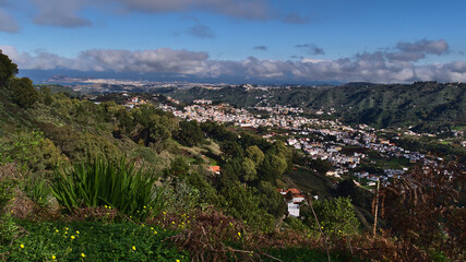 Fototapeta na wymiar Beautiful panoramic view over the northeast of island Gran Canaria, Canary Islands, Spain with town Teror between hills covered by green vegetation.