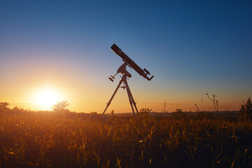 Astronomical telescope under a twilight sky ready for stargazing.